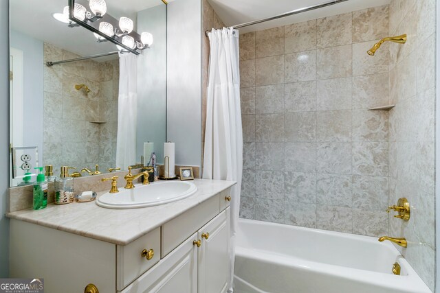 bathroom featuring shower / tub combo and vanity