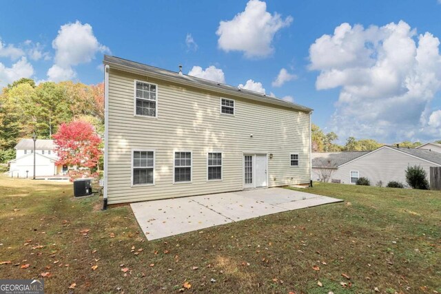 rear view of house featuring central AC, a lawn, and a patio area