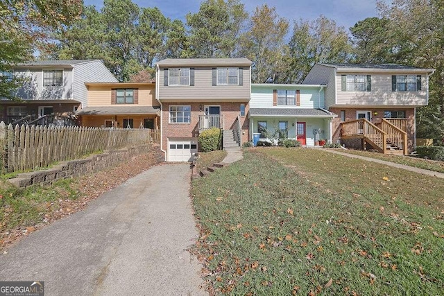 view of front of property with a garage and a front lawn