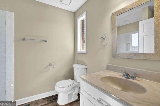 bathroom featuring hardwood / wood-style floors, vanity, and toilet