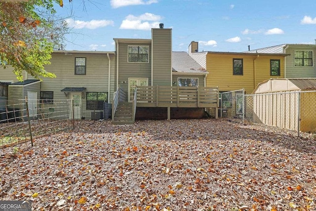 rear view of house featuring central AC and a deck