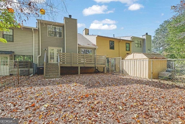 rear view of property featuring a wooden deck