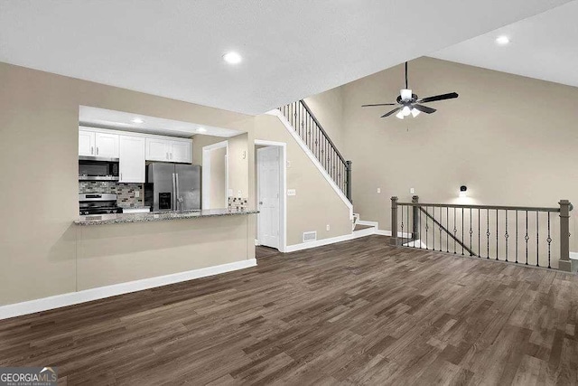 unfurnished living room with high vaulted ceiling, ceiling fan, and dark hardwood / wood-style floors