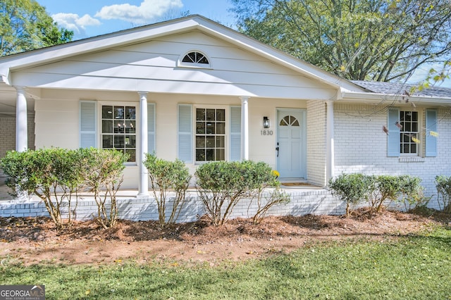 view of front of property featuring covered porch and brick siding