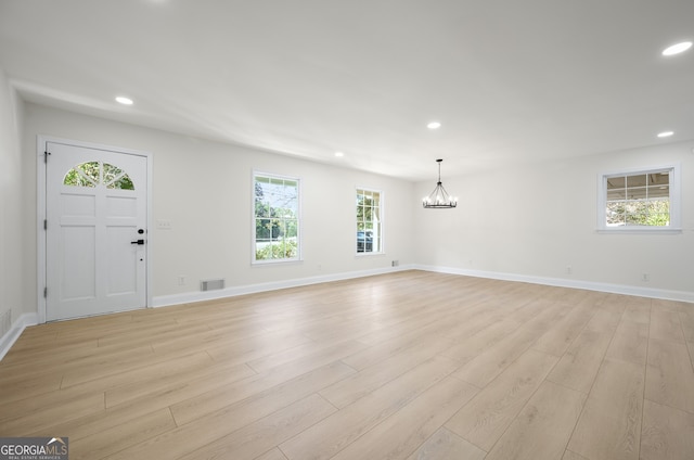 entryway featuring light wood-type flooring, visible vents, a chandelier, and recessed lighting