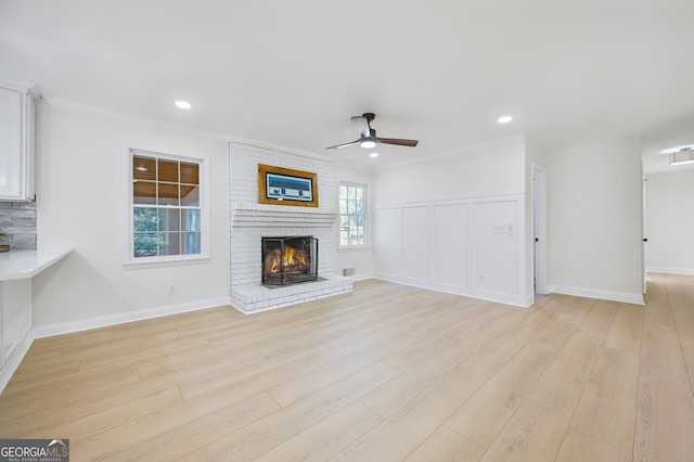 unfurnished living room with light wood-style flooring, a fireplace, ceiling fan, and recessed lighting