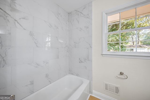 full bathroom with shower / tub combination, visible vents, and baseboards