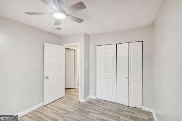 unfurnished bedroom with a closet, light hardwood / wood-style flooring, and ceiling fan