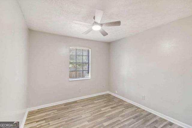 unfurnished room with ceiling fan, light hardwood / wood-style floors, and a textured ceiling