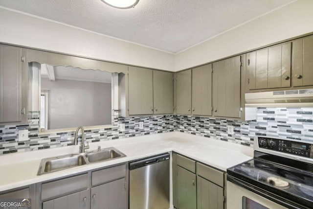 kitchen with decorative backsplash, sink, a textured ceiling, and appliances with stainless steel finishes