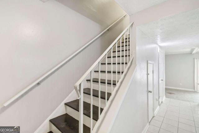 stairway with tile patterned floors