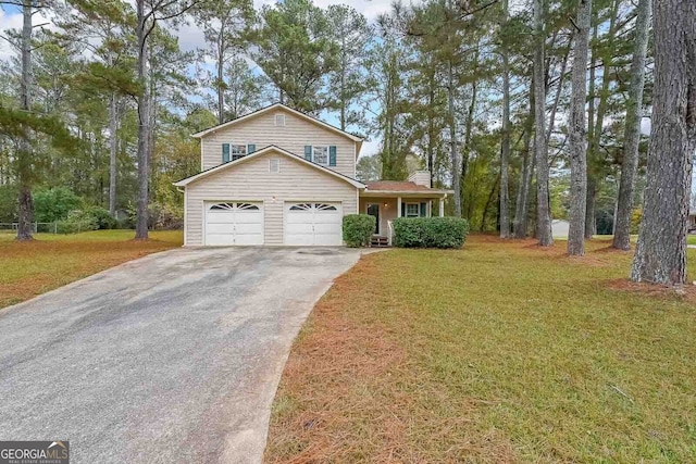 view of front facade with a front yard and a garage