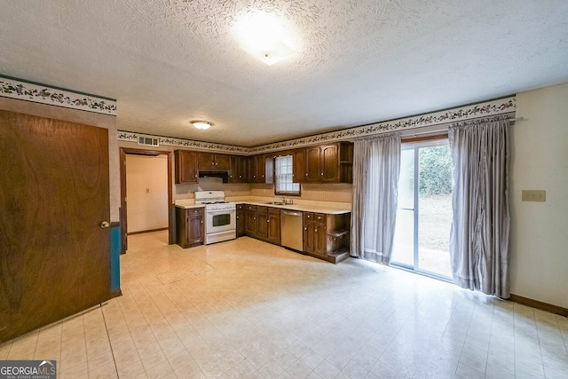 kitchen featuring sink, dishwasher, a textured ceiling, dark brown cabinets, and white gas range oven