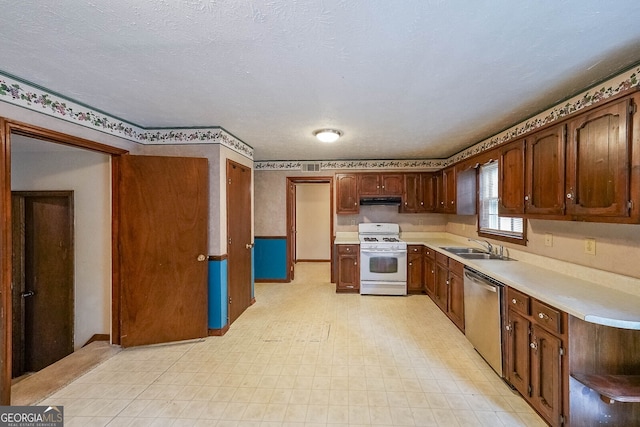 kitchen featuring dishwasher, white range with gas cooktop, sink, and a textured ceiling