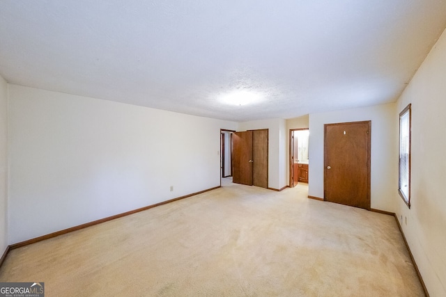 unfurnished room with light carpet