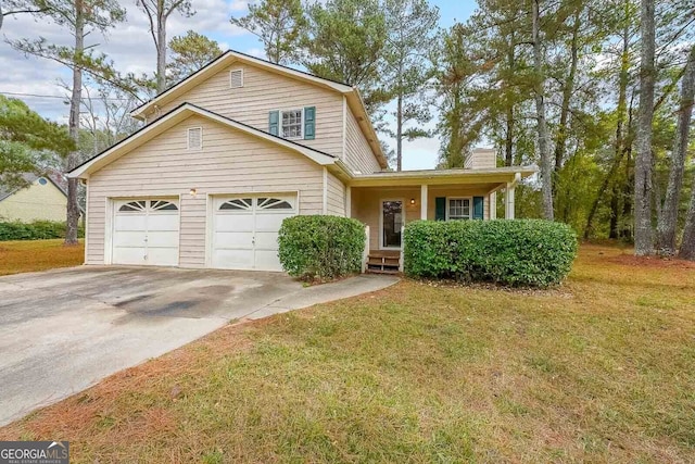 front of property with a front yard and a garage