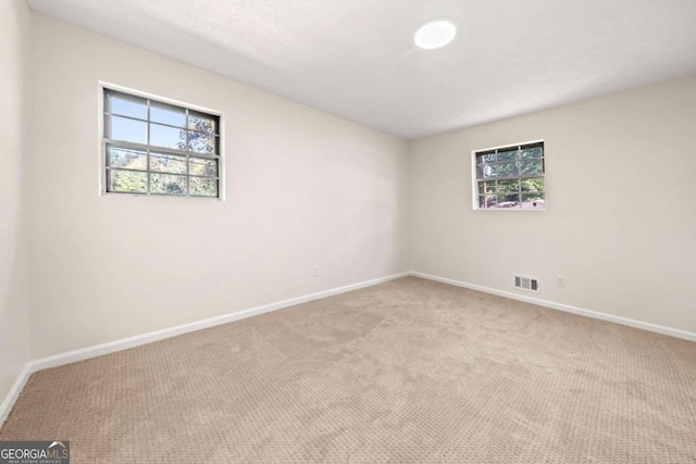 empty room featuring light colored carpet