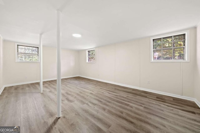 basement with dark hardwood / wood-style floors