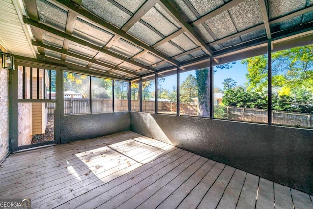 unfurnished sunroom featuring vaulted ceiling