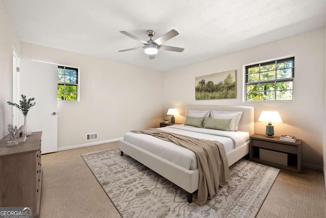 bedroom featuring light carpet and ceiling fan