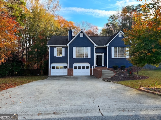 view of front of house featuring a front yard and a garage