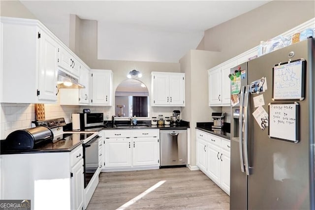 kitchen featuring appliances with stainless steel finishes, light hardwood / wood-style flooring, and white cabinetry