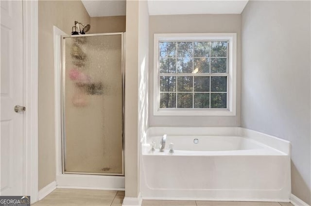 bathroom featuring tile patterned flooring and separate shower and tub