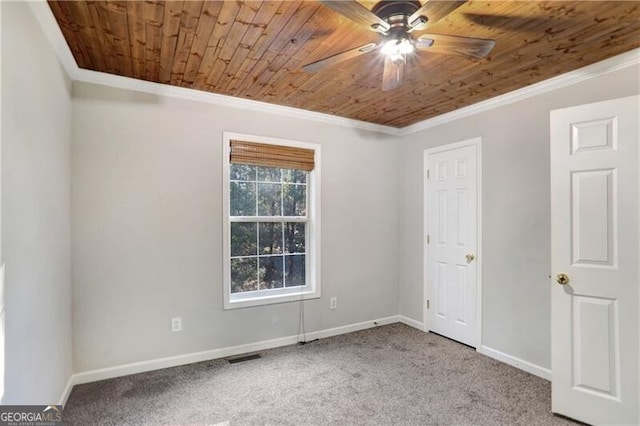 unfurnished bedroom with ceiling fan, crown molding, wood ceiling, and carpet floors