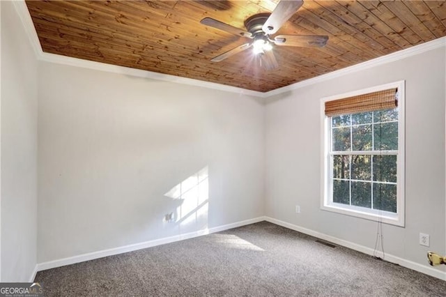 carpeted spare room with ornamental molding, ceiling fan, and wooden ceiling