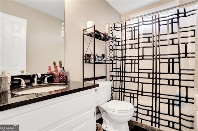 bathroom featuring vanity and toilet