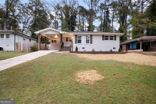 ranch-style house featuring a carport and a front lawn