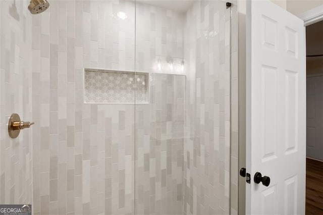 bathroom with tiled shower