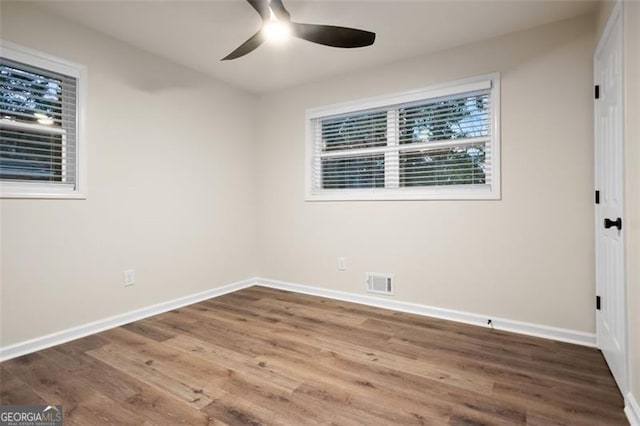 unfurnished room featuring hardwood / wood-style floors and ceiling fan