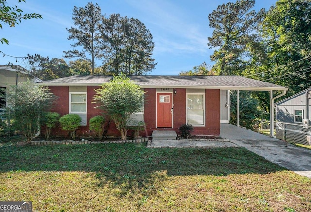 view of front of house with a front yard and a carport