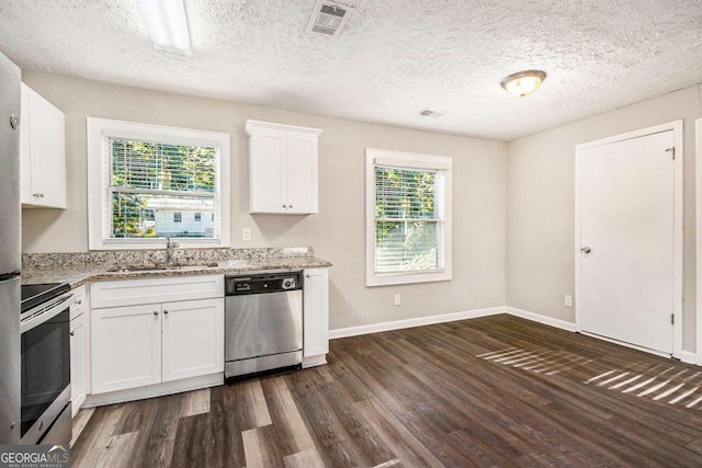 kitchen with plenty of natural light, white cabinetry, sink, and appliances with stainless steel finishes