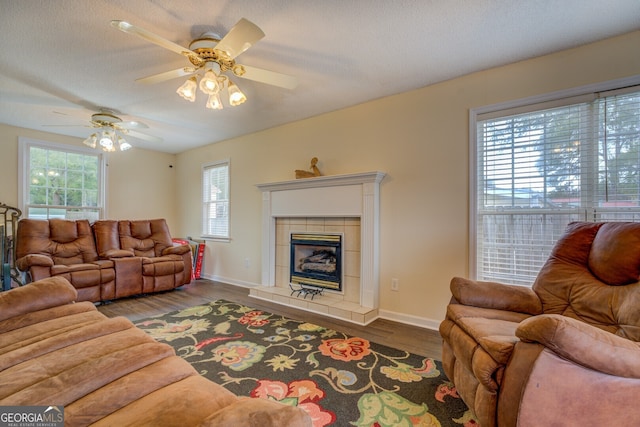 living room featuring ceiling fan, hardwood / wood-style floors, and plenty of natural light