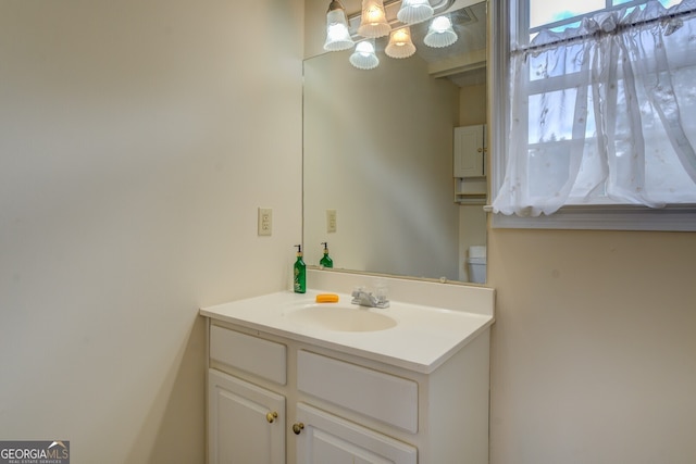 bathroom featuring vanity and toilet