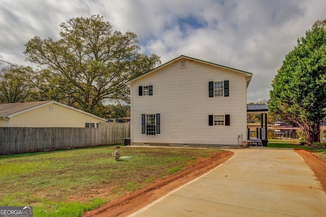 view of property exterior with a yard and central air condition unit