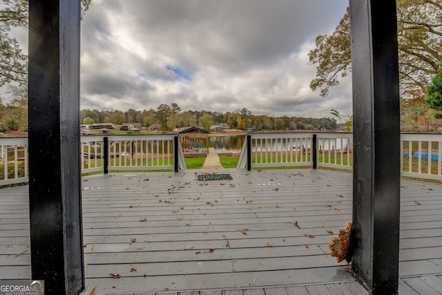 wooden terrace featuring a water view