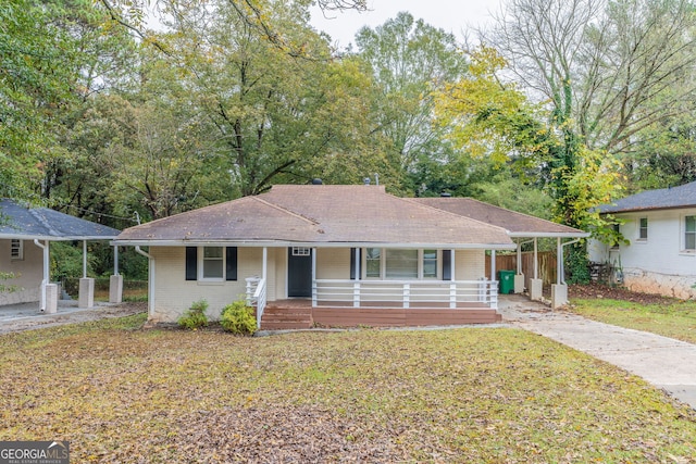 ranch-style home with a porch, a carport, and a front lawn