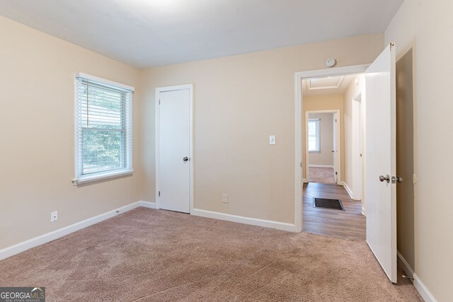 unfurnished bedroom with light colored carpet