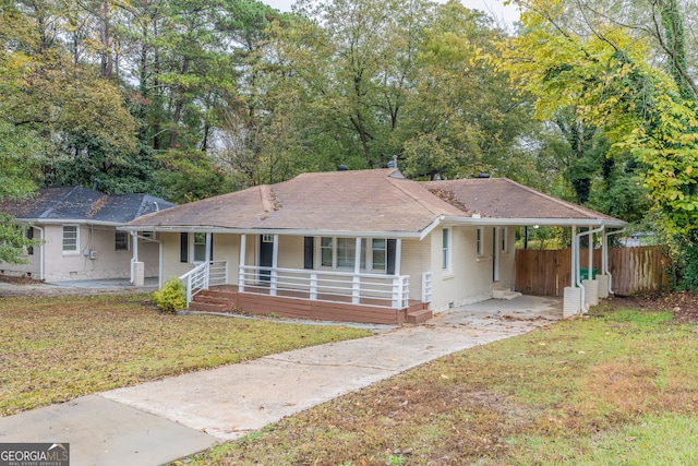 single story home featuring a carport, a porch, and a front lawn