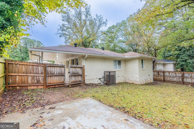 rear view of house with a patio area and a lawn