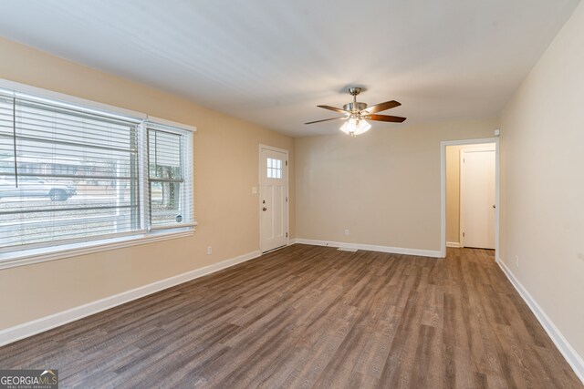 spare room with ceiling fan and dark hardwood / wood-style flooring