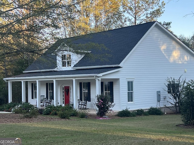 view of front of property with covered porch and a front yard