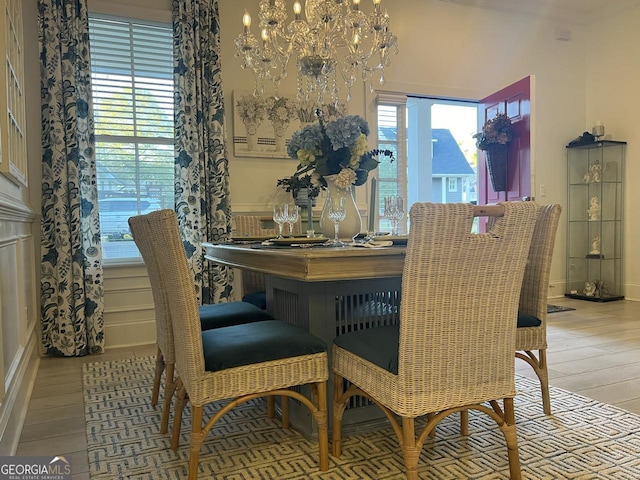 dining space featuring an inviting chandelier, wood-type flooring, and a wealth of natural light