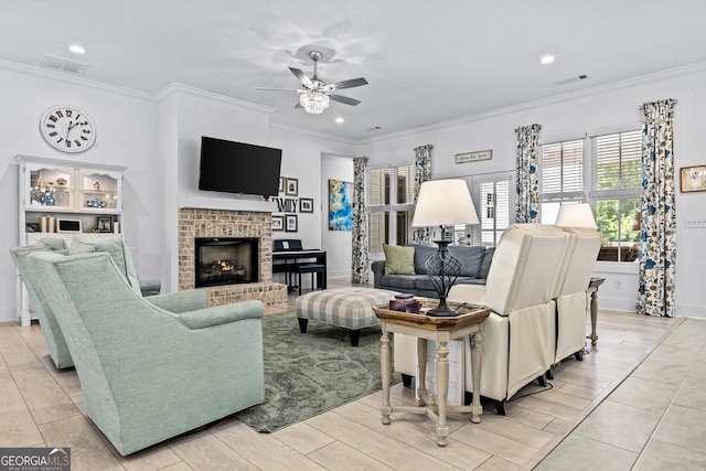 living room with a fireplace, ornamental molding, and ceiling fan