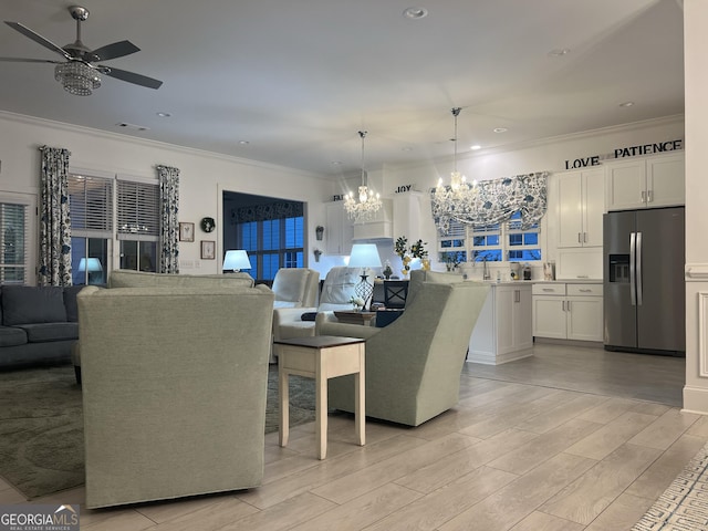 dining area with ornamental molding and ceiling fan with notable chandelier