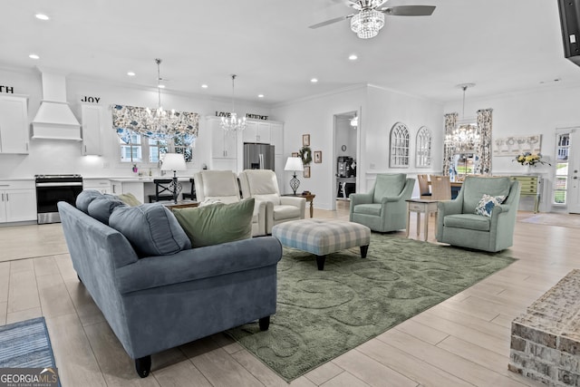 living room featuring ceiling fan with notable chandelier and ornamental molding