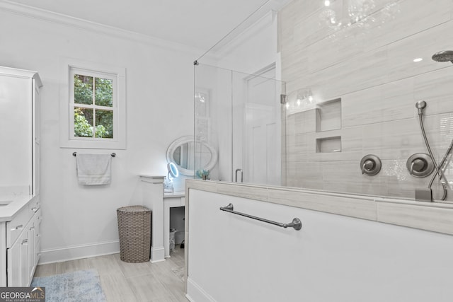 bathroom featuring vanity, ornamental molding, and a shower with shower door